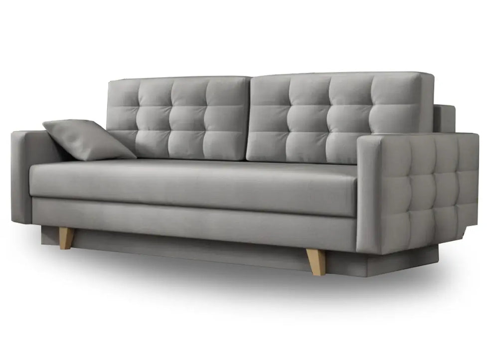 Szara sofa z pikowanymi poduszkami i boczkami oraz z funkcją spania