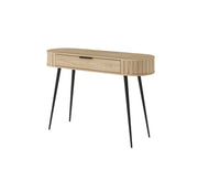 Toaletka LOVI widoczna pod lekkim kątem, z owalnym blatem i czarnymi, smukłymi nogami.