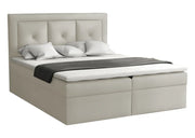 Kremowe łóżko z pikowanym wezgłowiem do sypialni