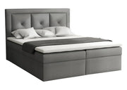 Ciemno szare łóżko z pikowanym wezgłowiem