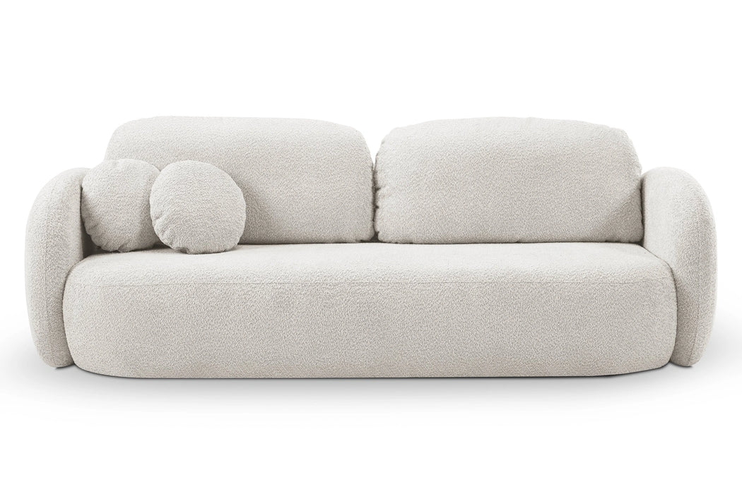 Kremowa sofa z okrągłymi poduszkami