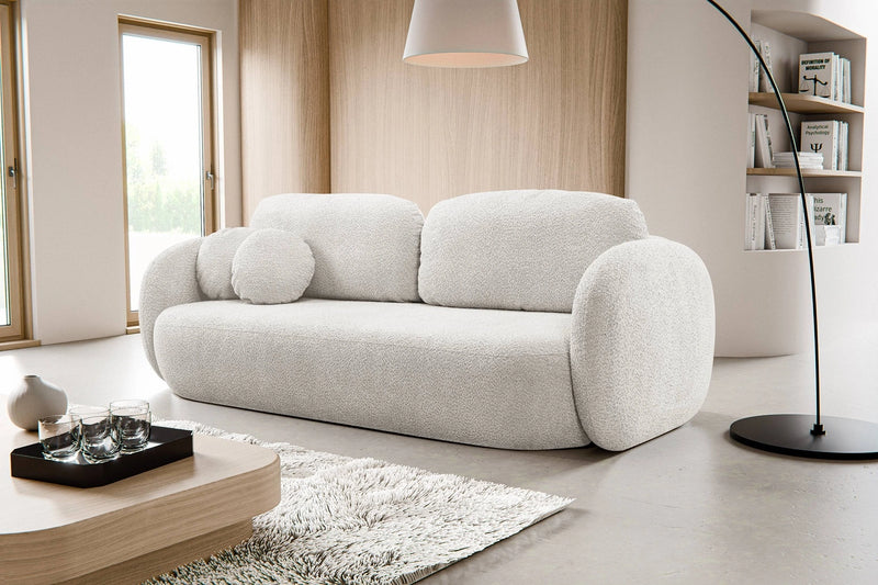 Kremowa sofa z funkcją spania w modnym salonie