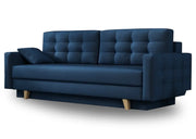 Granatowa sofa z pikowanymi poduszkami i naturalnymi nóżkami 